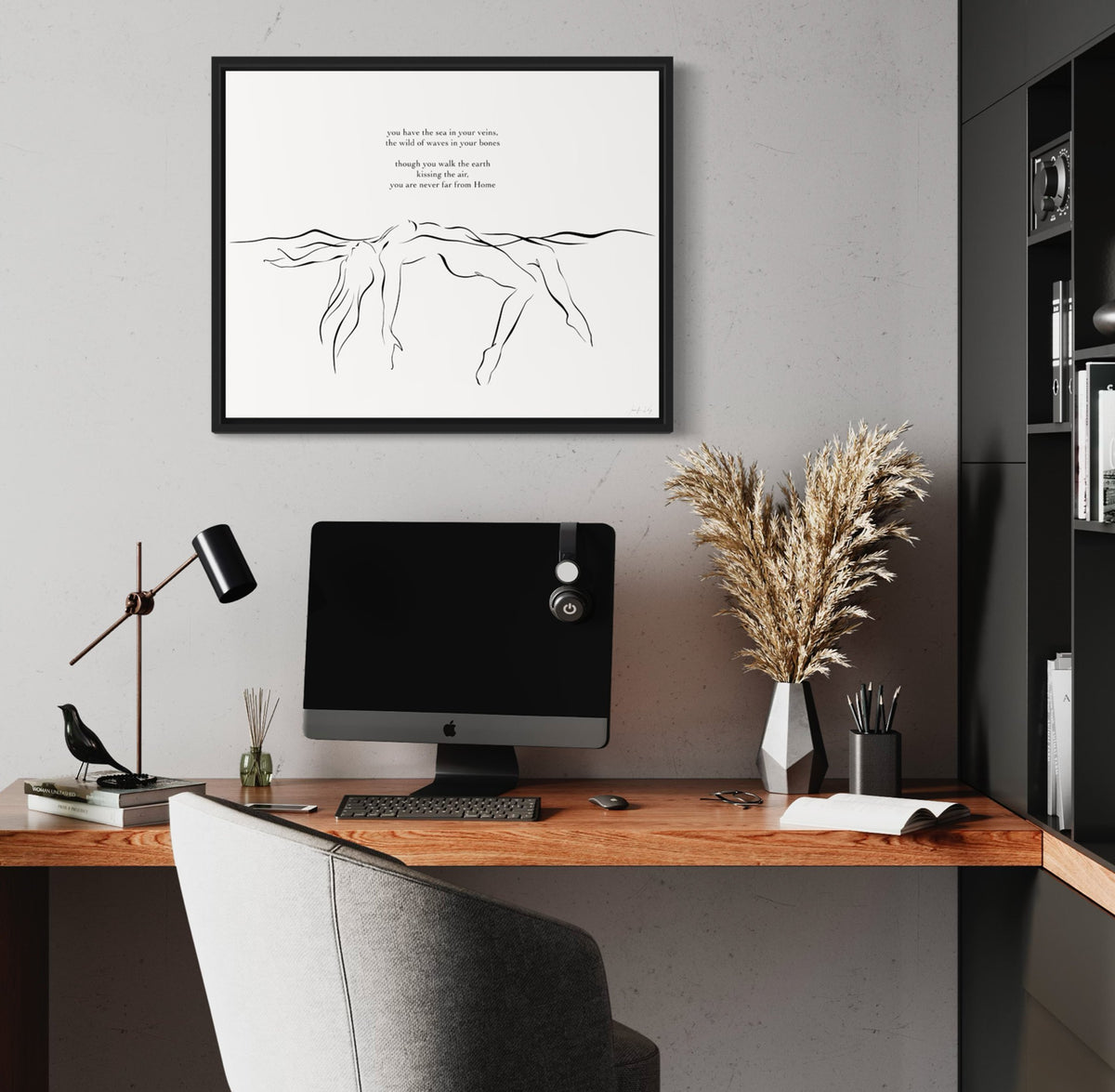 Black and white elegant line art illustration of sensual woman floating in water; in black frame in modern office setting.