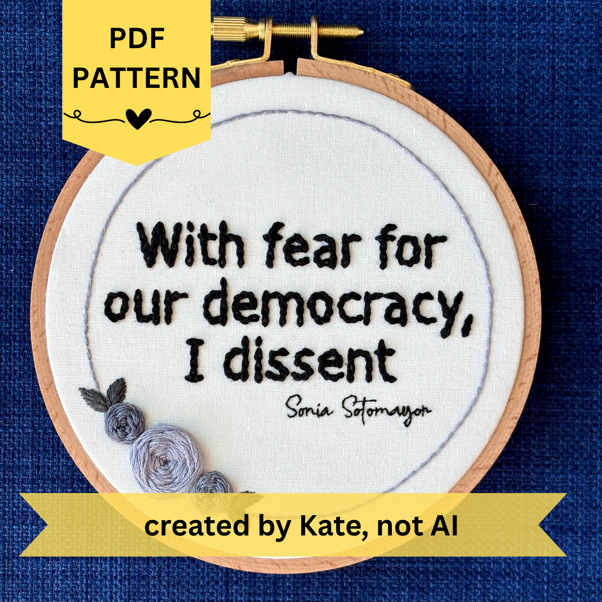 PDF Pattern created by Kate, not AI. "With fear for our democracy, I dissent. Sonia Sotomayor" Quote hand embroidered in a strong sans-serif font in black embroidery thread. A floral wreath of light and medium gray roses surrounds the text. Fabric is white cotton. Embroidery is displayed as wall art in a wood embroidery hoop.