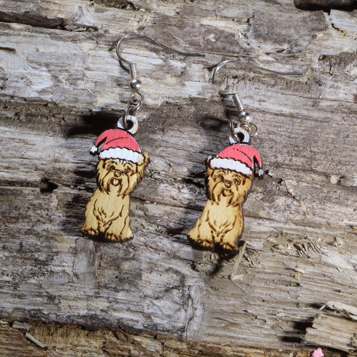 Hand-painted wooden Yorkie with Santa hat dangle earrings featuring an adorable Yorkshire Terrier wearing a festive red and white Santa hat. Lightweight Christmas dog earrings with hypoallergenic .925 sterling silver hooks, perfect for Yorkie lovers, dog moms, holiday parties, Christmas celebrations, and festive seasonal outfits.