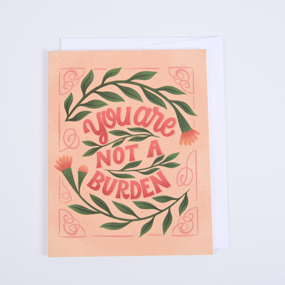 A folded greeting card with a floral pattern and the message &