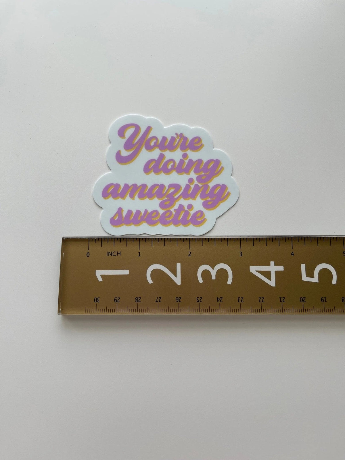You’re doing amazing sweetie sticker flat lay — funny affirmation laptop and water bottle sticker by indie artist MangoIllustrated