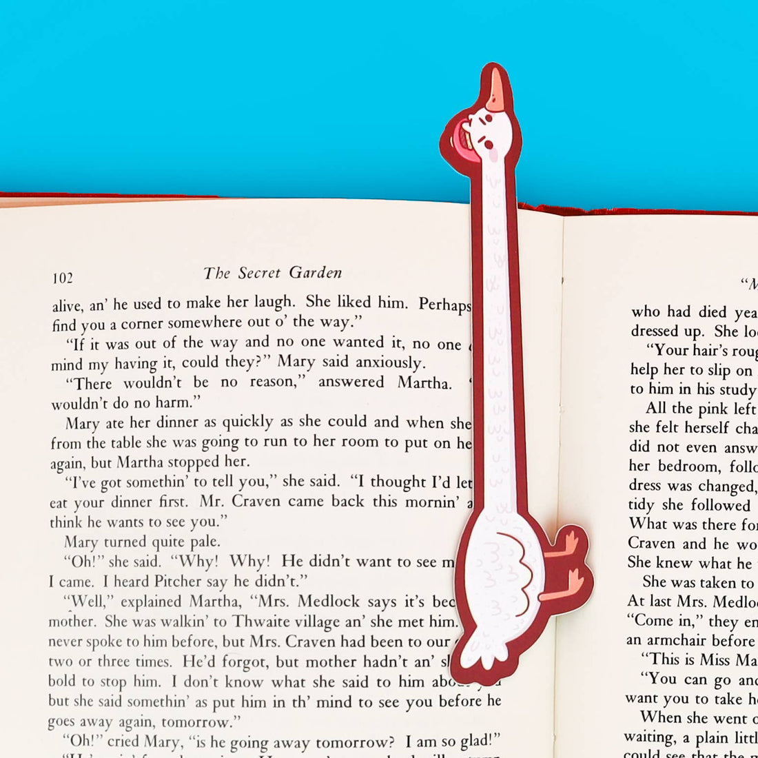 Goose-shaped bookmark on an open book with a blue background