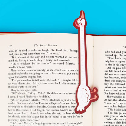 Goose-shaped bookmark on an open book with a blue background