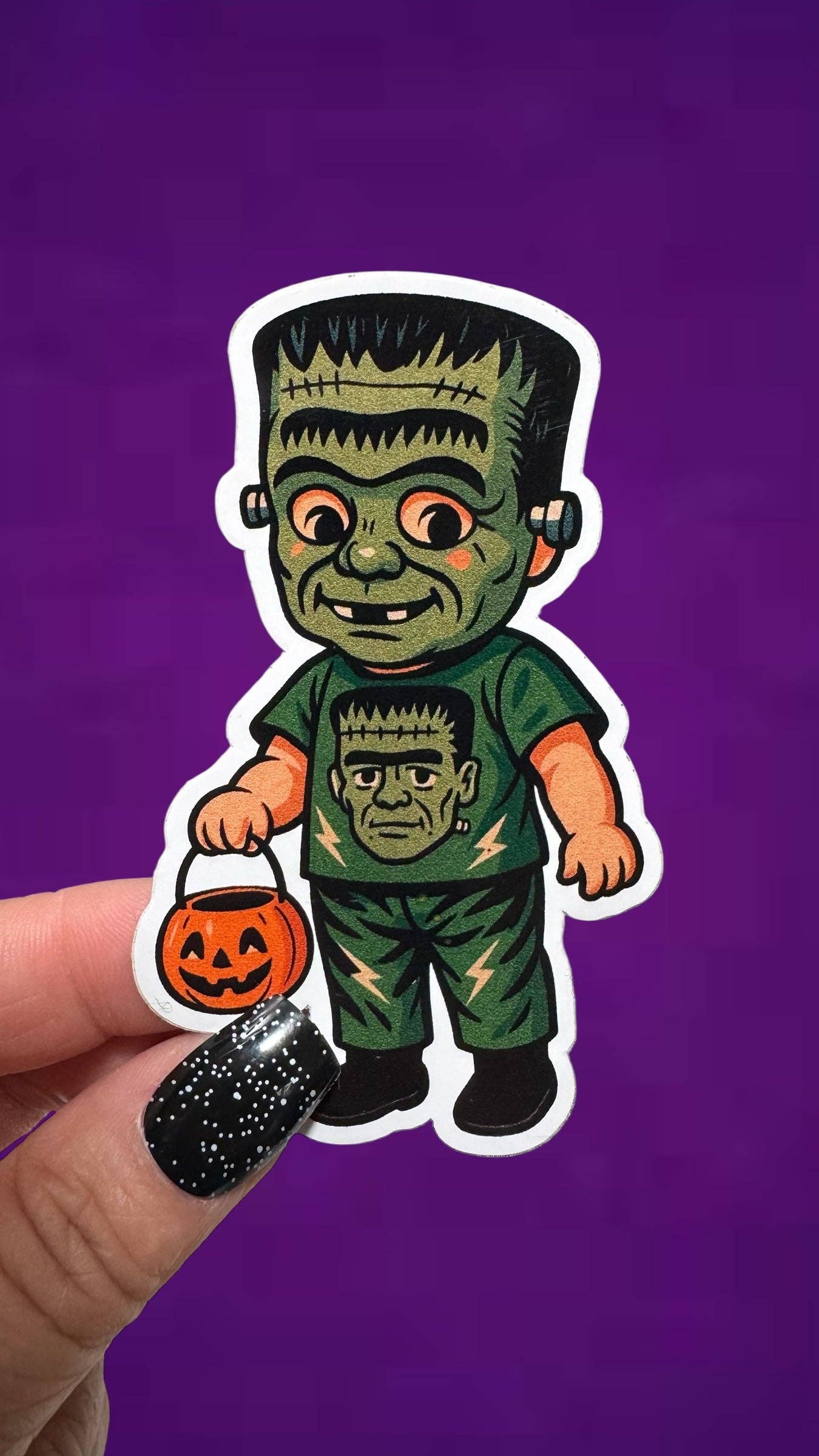Sticker of a green monster character with a pumpkin and black glove on a purple background