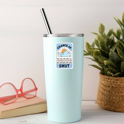 Light blue tumbler with a graphic design on a white surface with a plant and glasses in the background