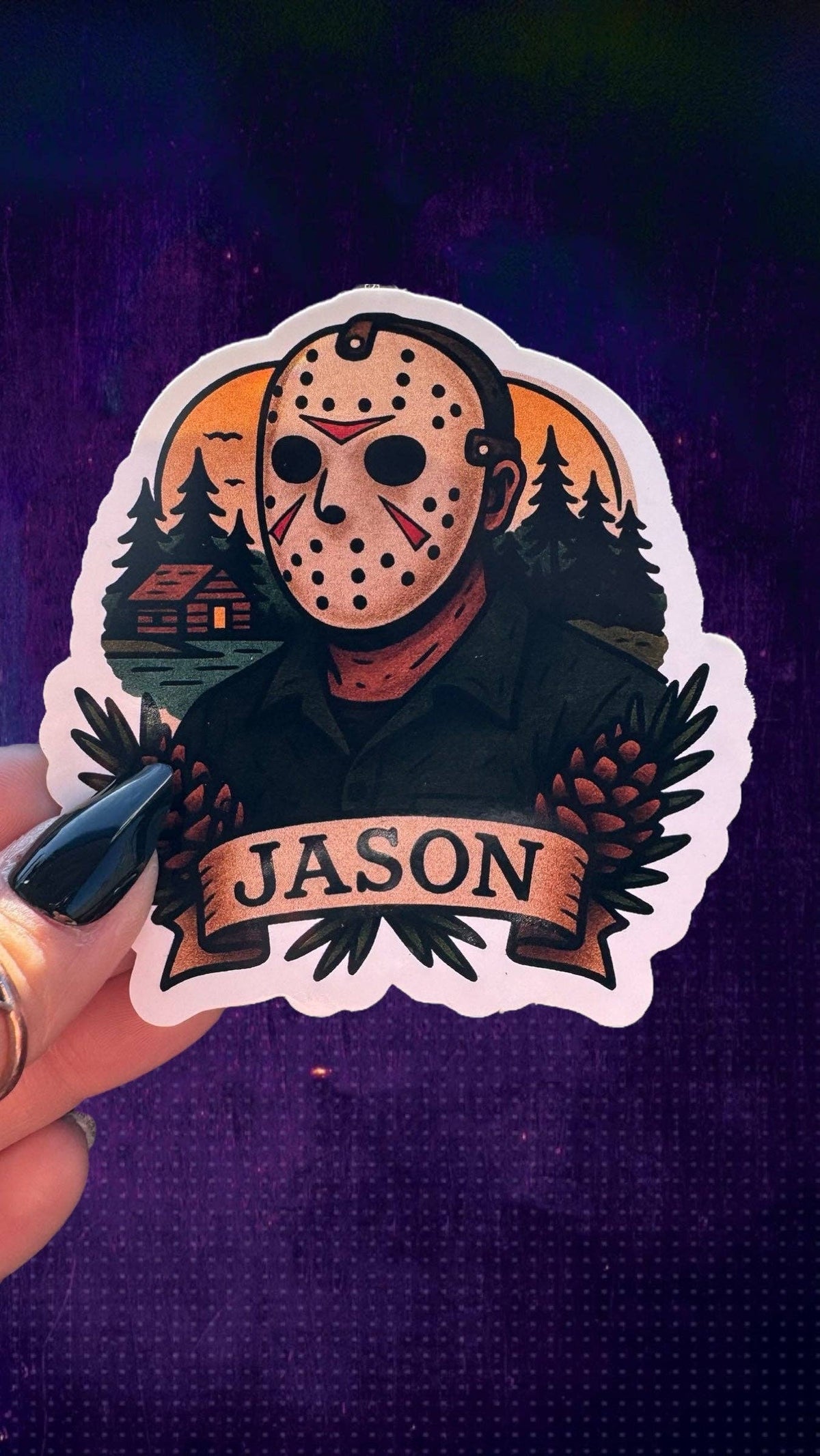 A die-cut sticker featuring a horror character in a hockey mask with pinecones and the name &