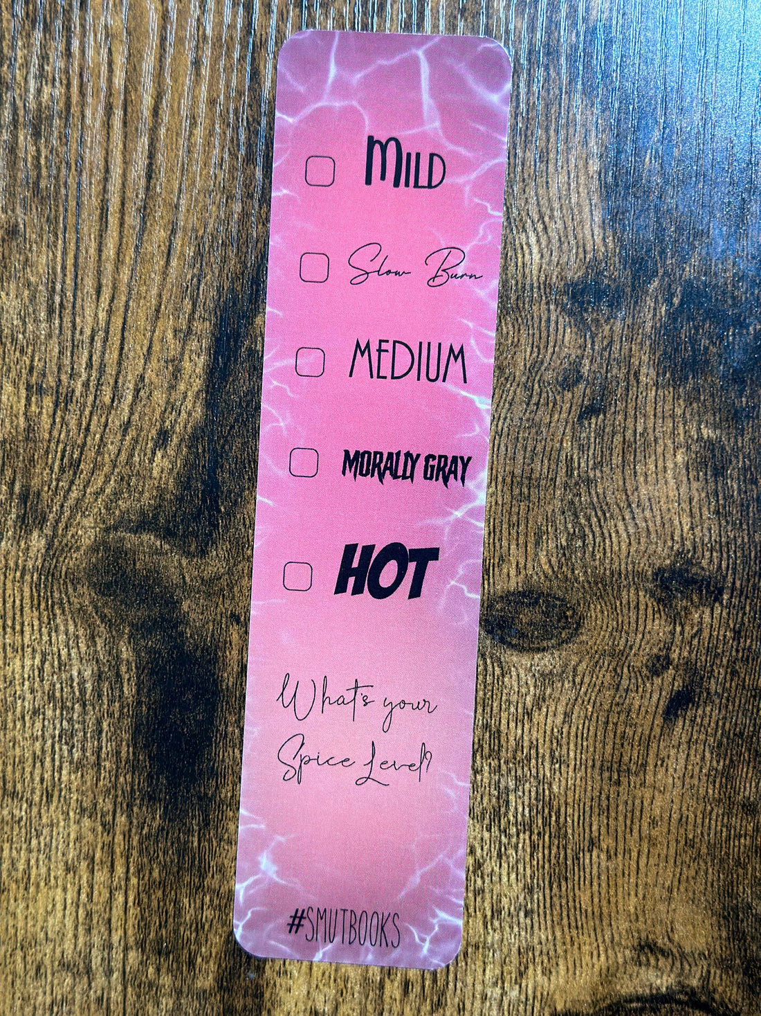 Pink label with text on a wooden surface