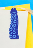 Blue circular patterned bookmark on a yellow and blue background