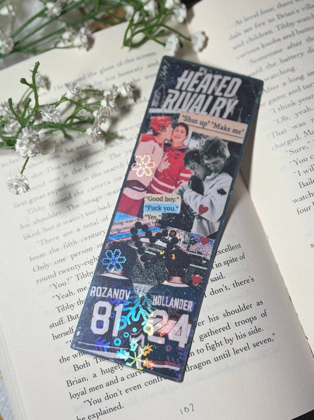 Bookmarks with images and text on a book page with flowers.