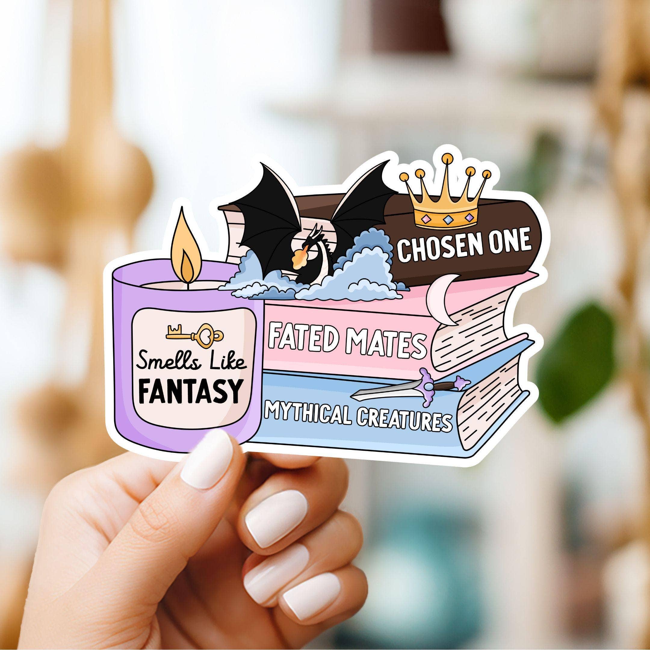 Sticker with fantasy elements held by a hand against a blurred background