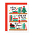 A Christmas greeting card with a white front featuring illustrated bookshelves, holiday books, a Christmas tree, an elf, a black cat, and festive text, shown with a red envelope behind it on a white background.