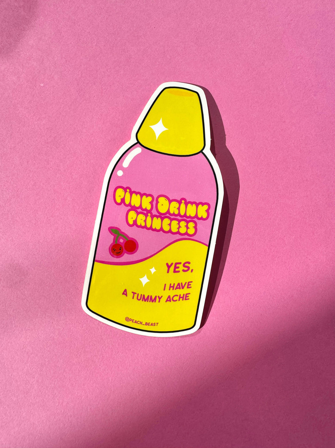 Sticker of a pink drink labeled &
