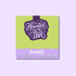 A square magnetic bookmark card with a lime green top section and a lavender bottom banner. The center features a dark purple label with the phrase &
