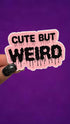 A hand with black glitter nail polish holds a die-cut sticker that reads &
