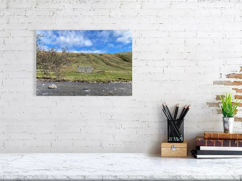 Sample print of a photograph of a stone cottage under a bright blue sky on the bank of the River Tilt in Scotland.