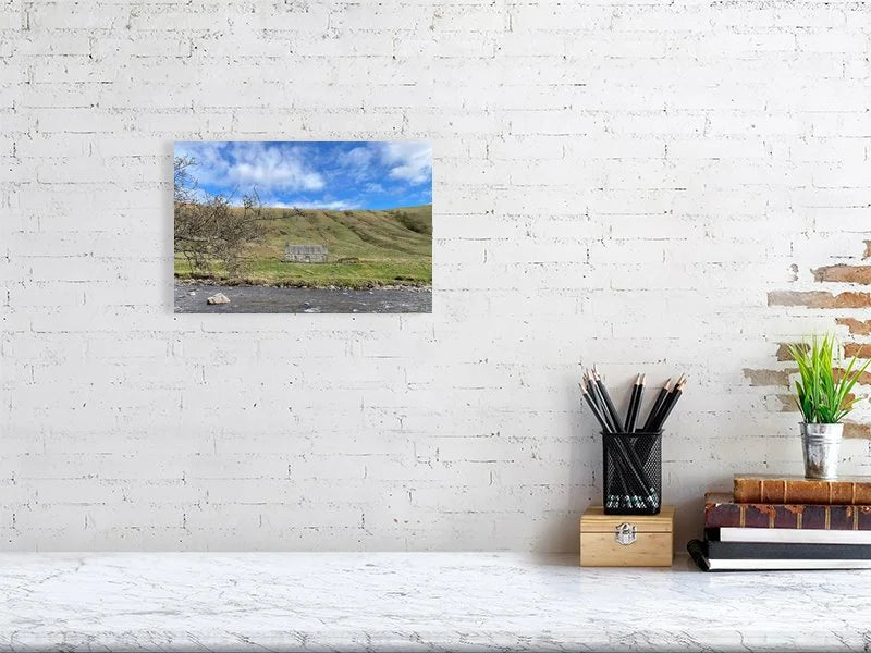 Sample print of a photograph of a stone cottage under a bright blue sky on the bank of the River Tilt in Scotland.