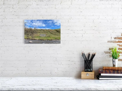 Sample print of a photograph of a stone cottage under a bright blue sky on the bank of the River Tilt in Scotland.