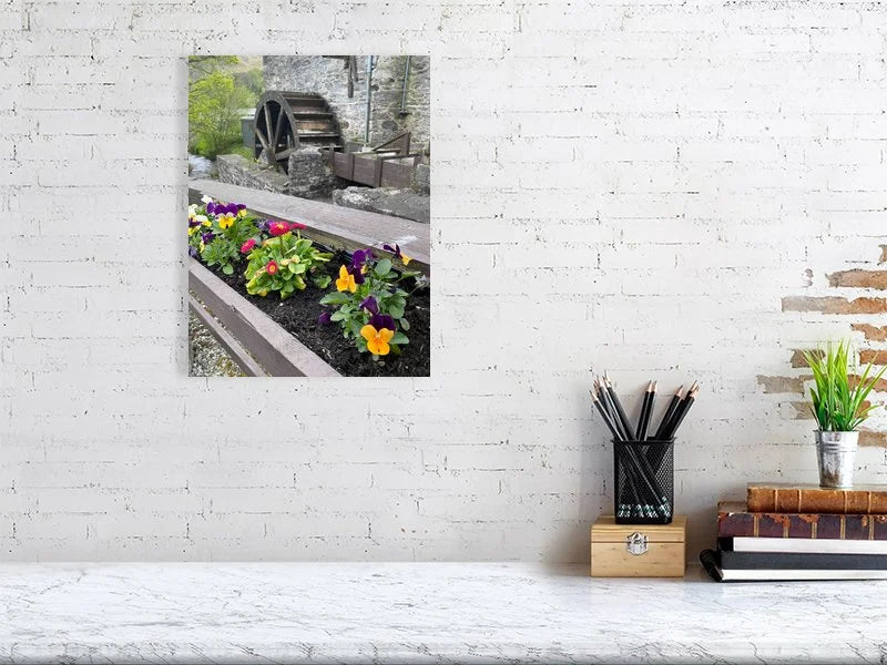 Fine art photograph of an antique wood and stone water mill waterwheel and a flower box taken in Scotland sample image.
