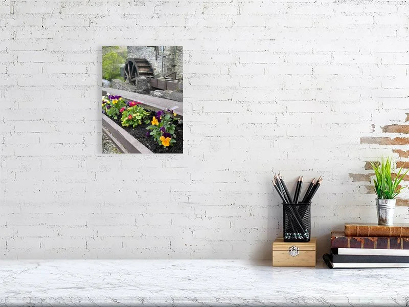 Fine art photograph of an antique wood and stone water mill waterwheel and a flower box taken in Scotland sample image.