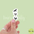 Hand holding a stack of small dragon stickers with &