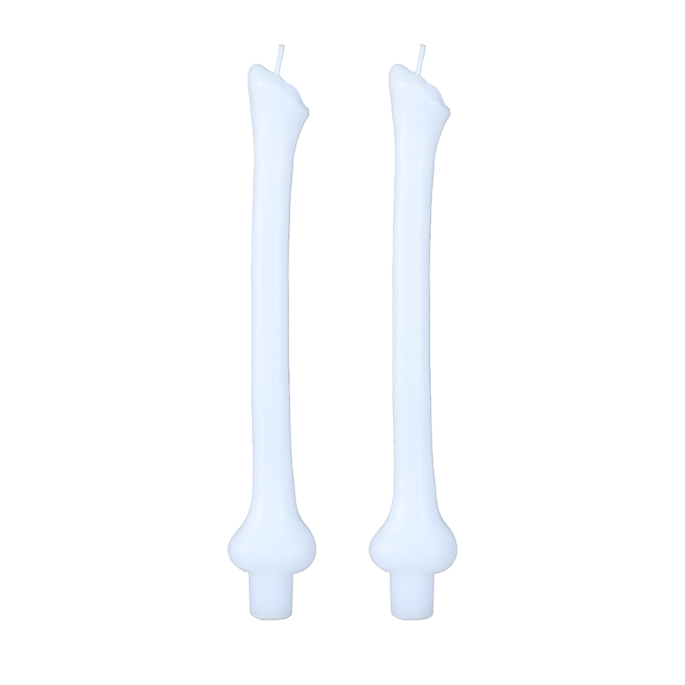 Pair of pale blue taper candles molded as stacked bones, on white.