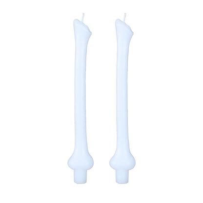 Pair of pale blue taper candles molded as stacked bones, on white.