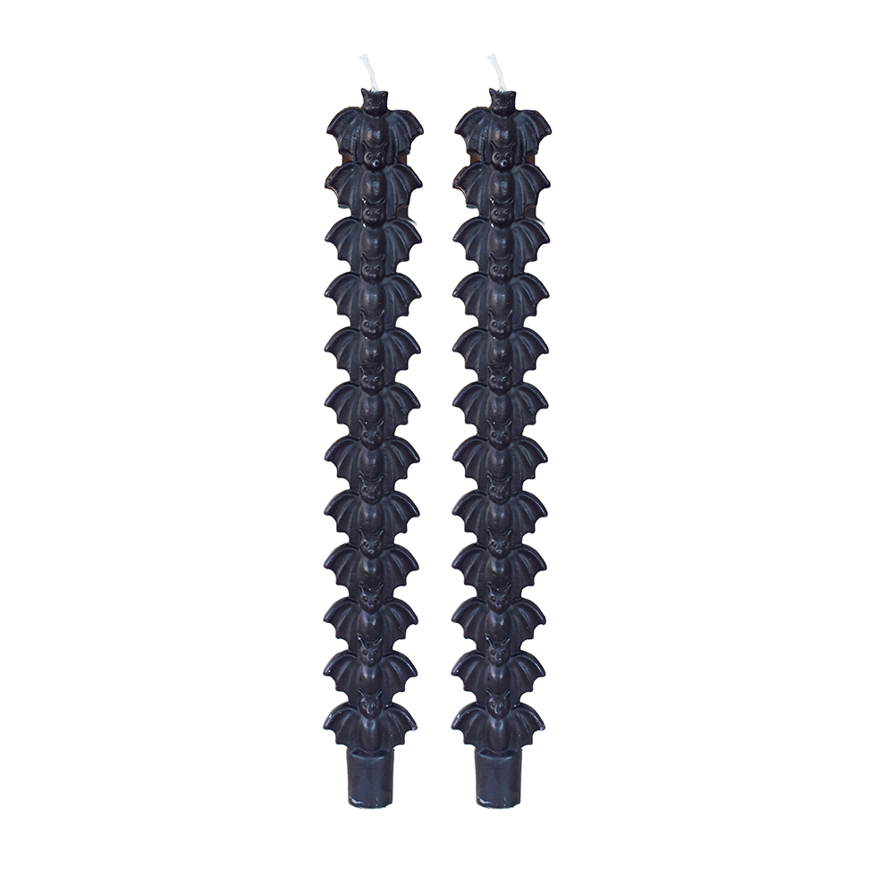 Pair of black taper candles molded with a stack of bat silhouettes, on white.