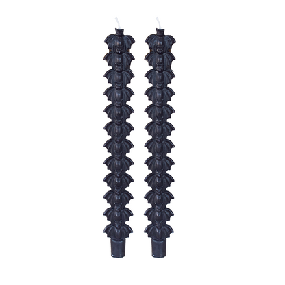 Pair of black taper candles molded with a stack of bat silhouettes, on white.