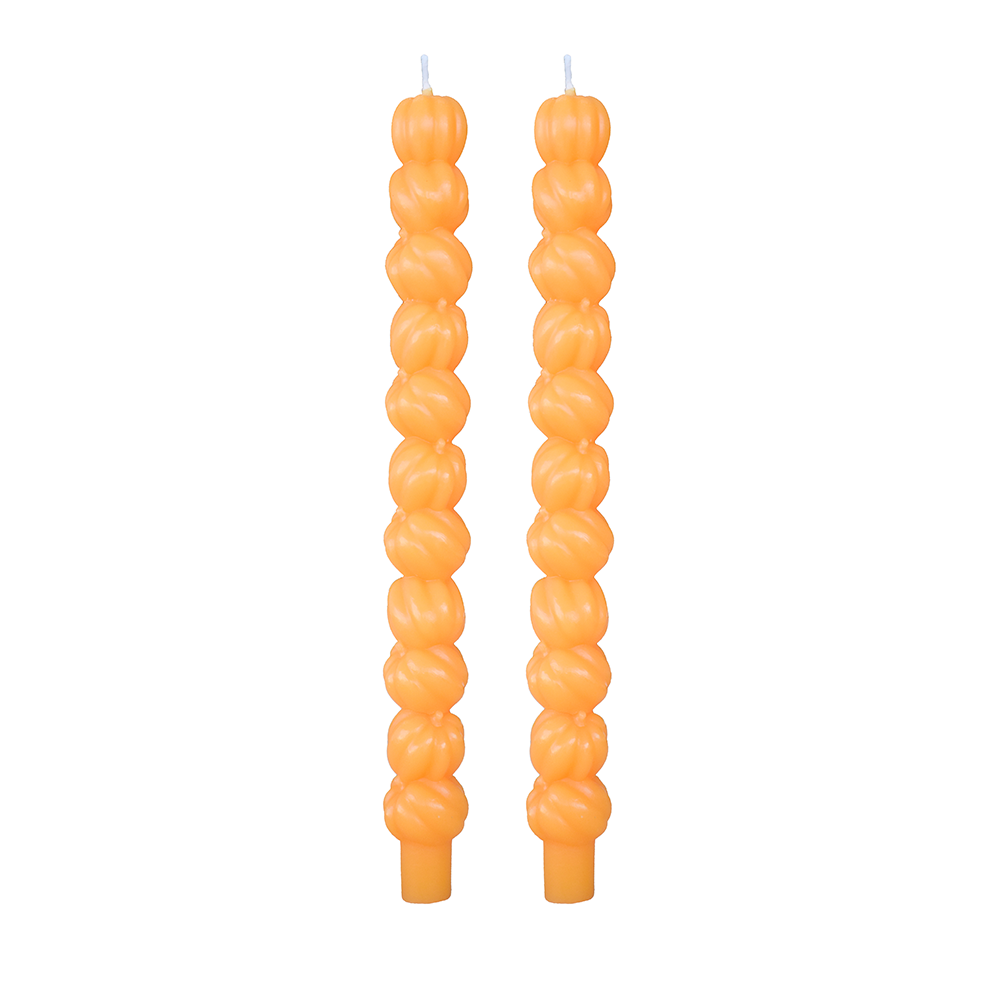 Pair of orange taper candles molded as stacked pumpkins, on white.