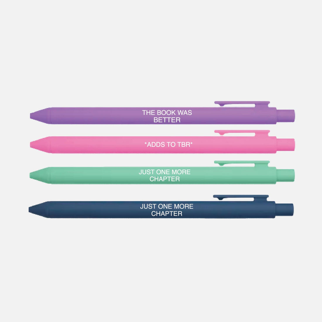 Four pens in different colors with book-themed text on a light gray background