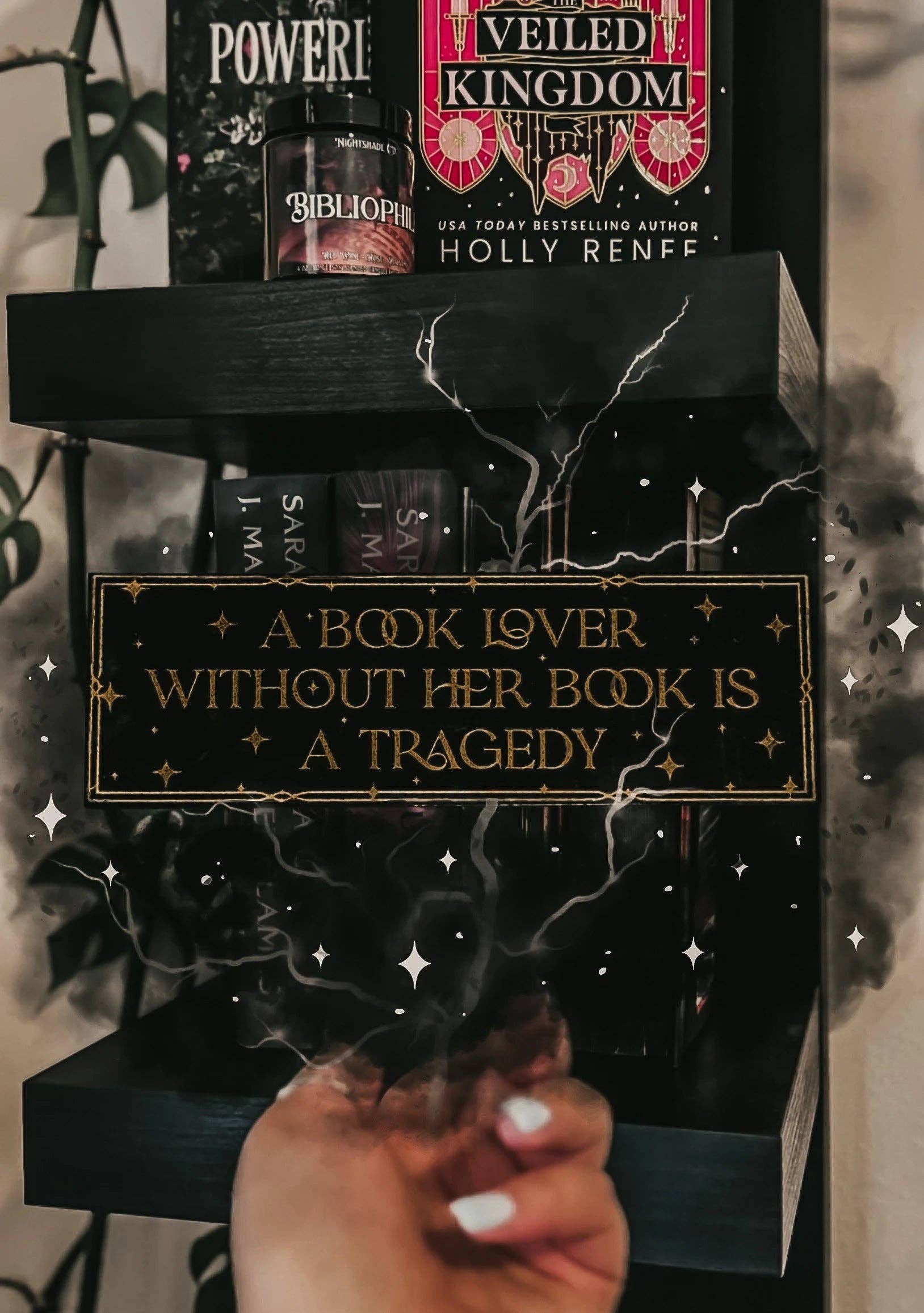 Stack of books with decorative boxes and a quote about books on a blurred background