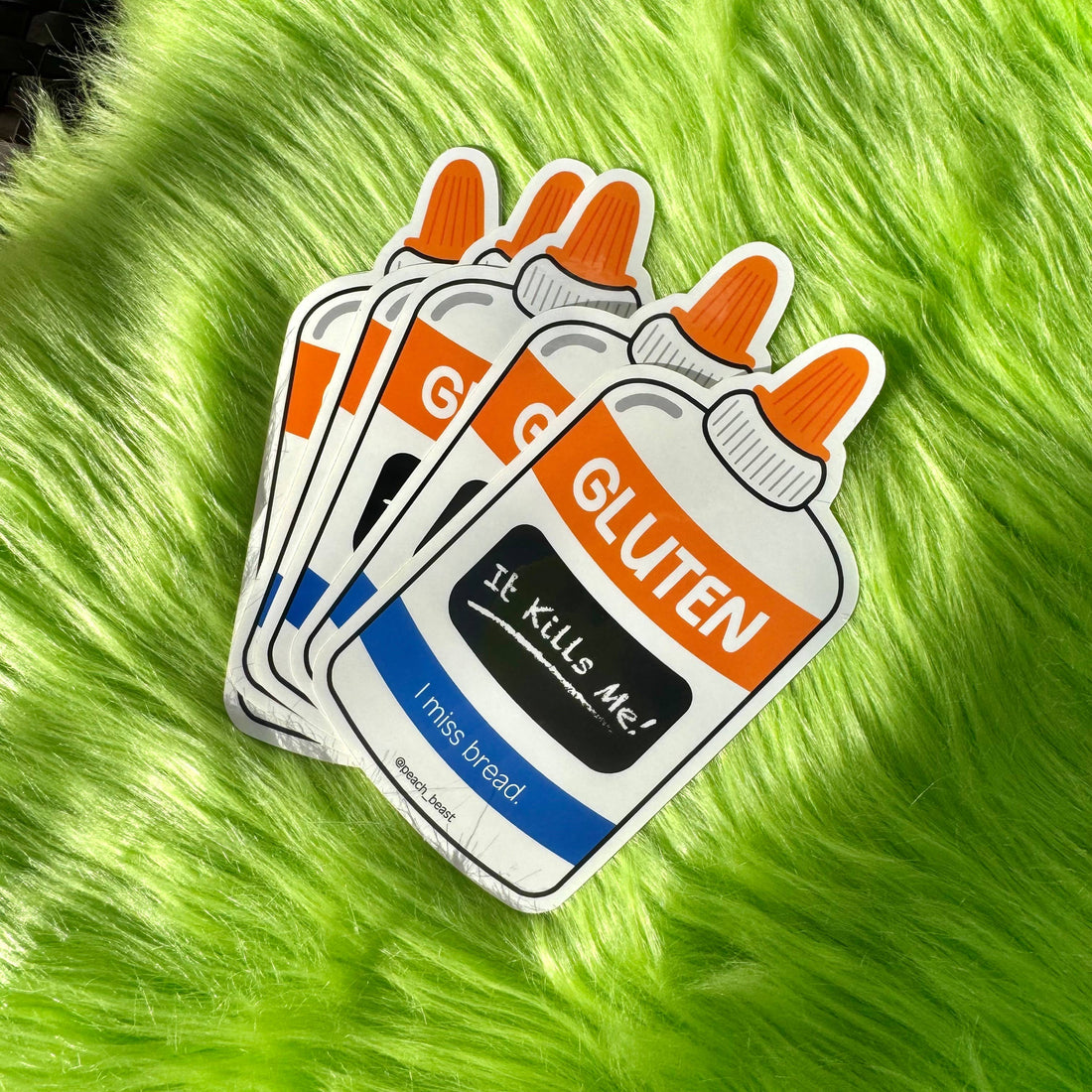 Sticker with gluten-themed design on a green furry background