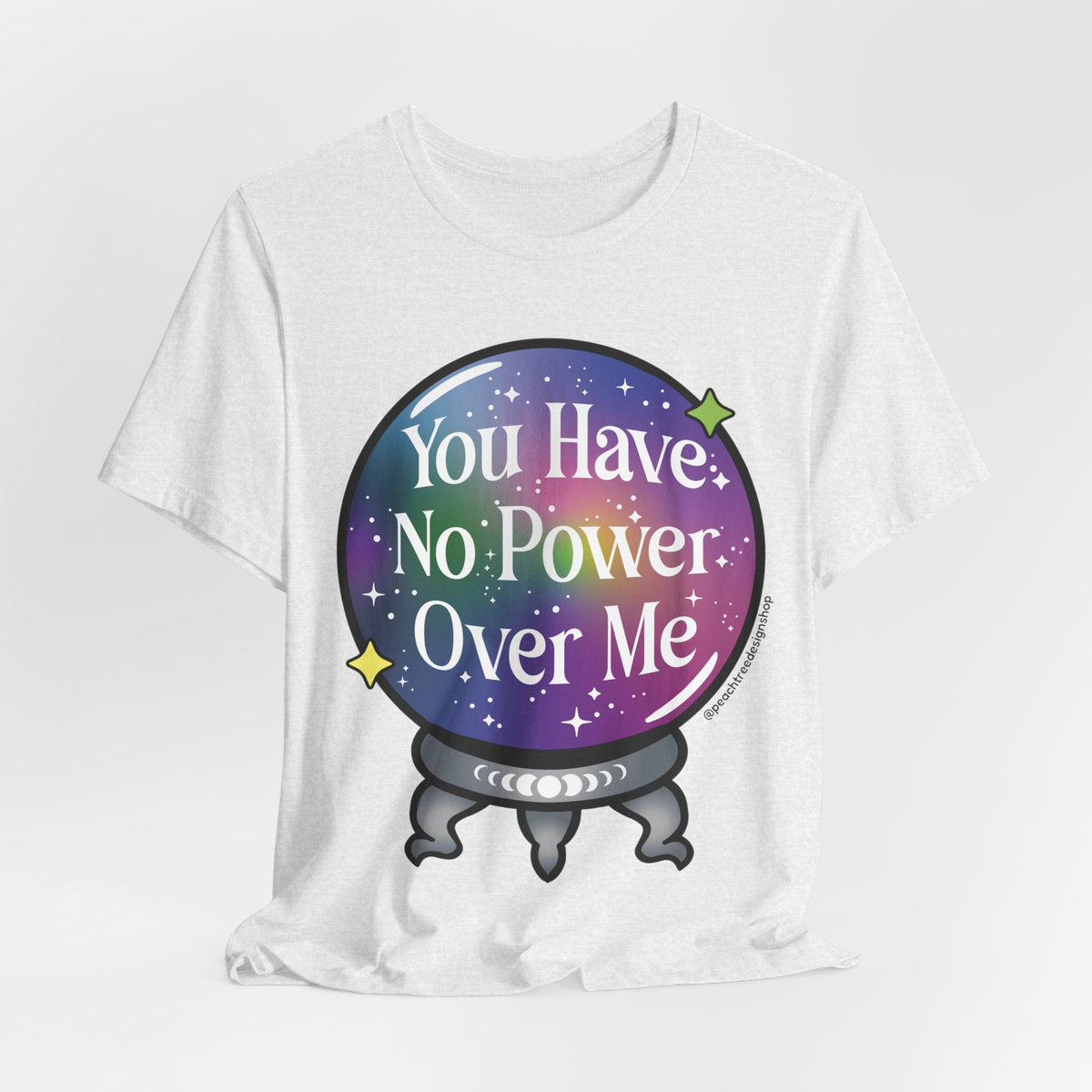 A white short-sleeve t-shirt with a graphic of a crystal ball containing a purple and blue galaxy design with the text &