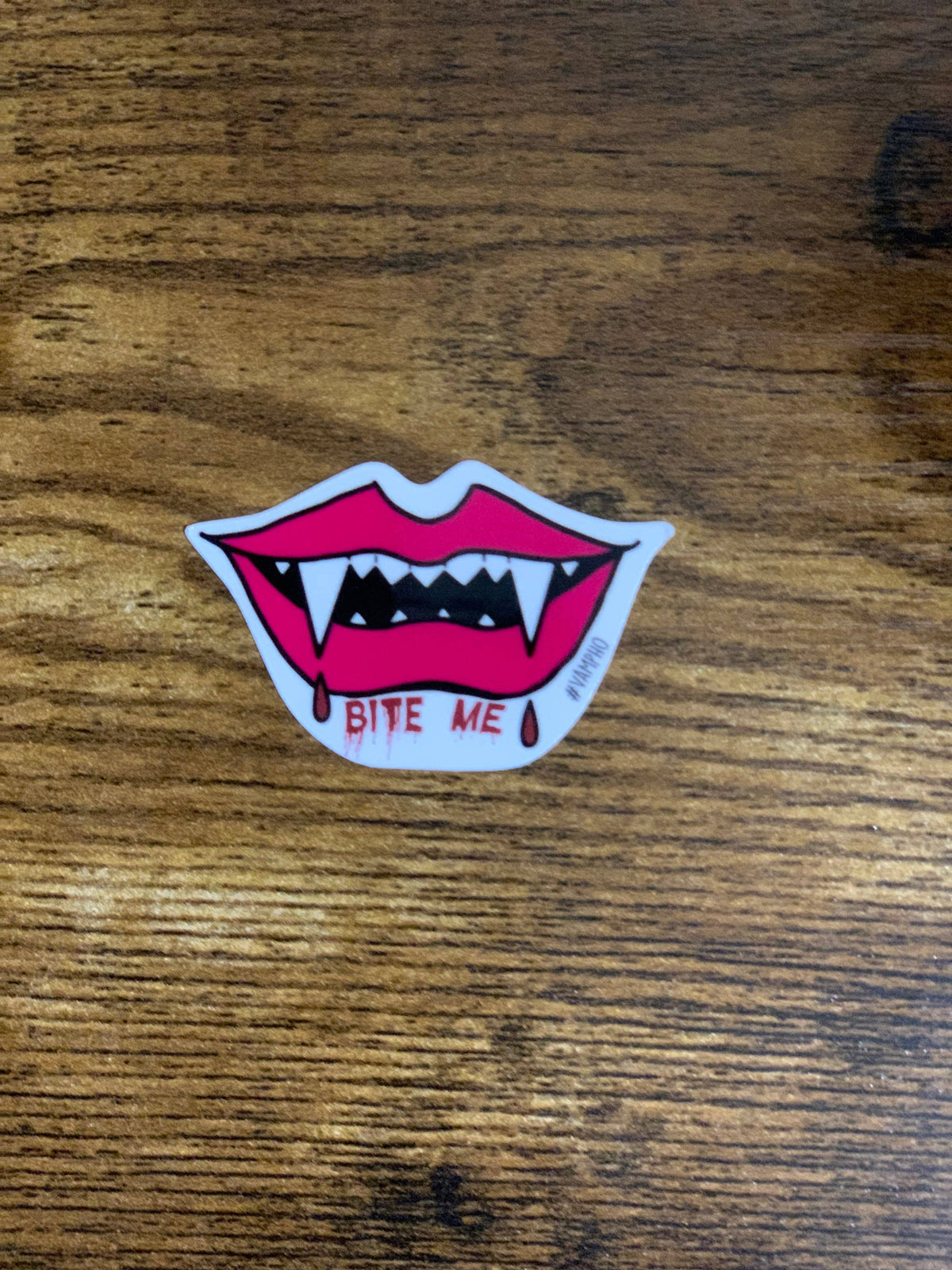 Sticker of a mouth with fangs and &
