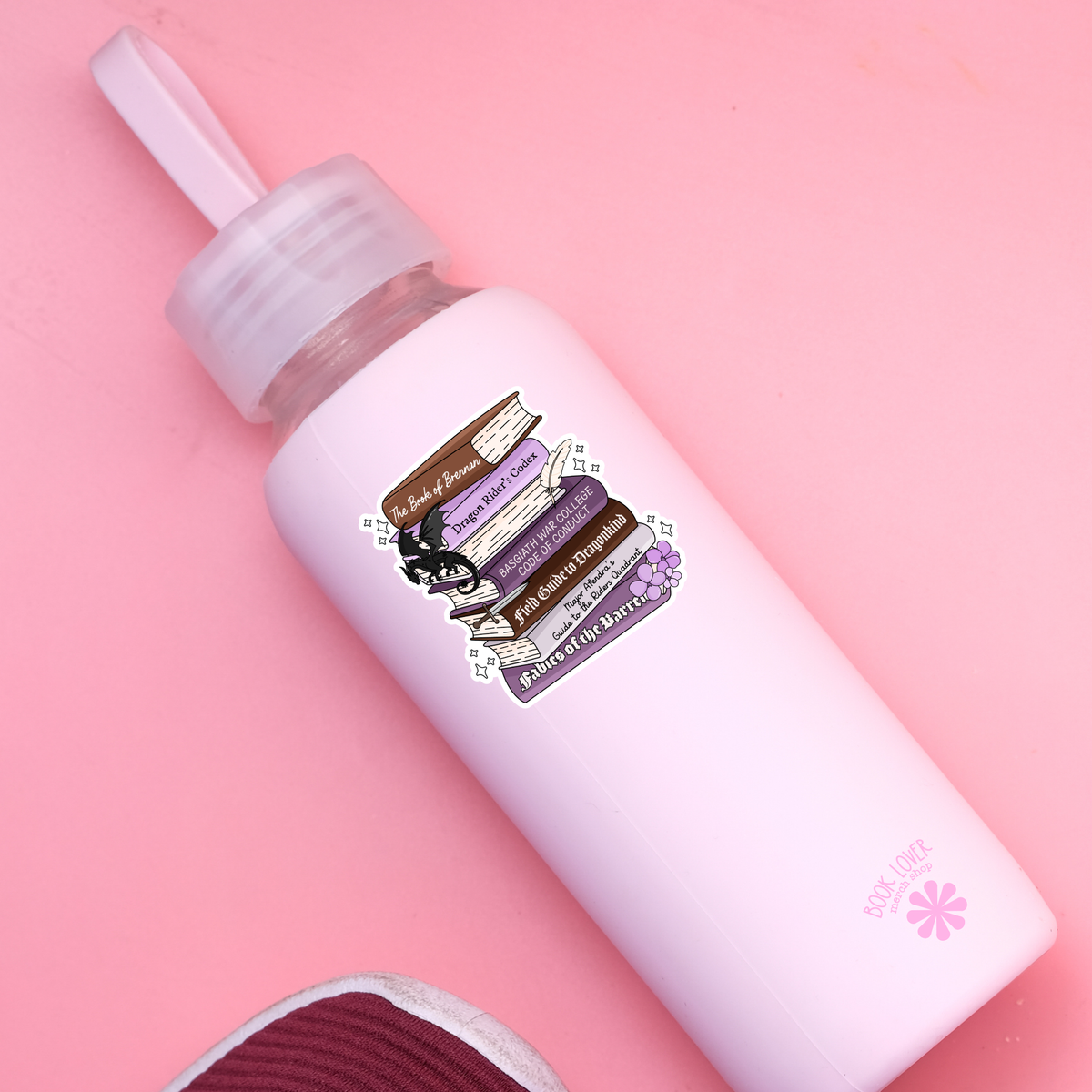White bottle with a purple label on a pink background