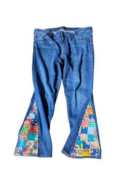 Blue jeans with colorful patchwork design on a white background