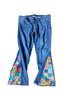 Blue jeans with colorful patchwork design on a white background