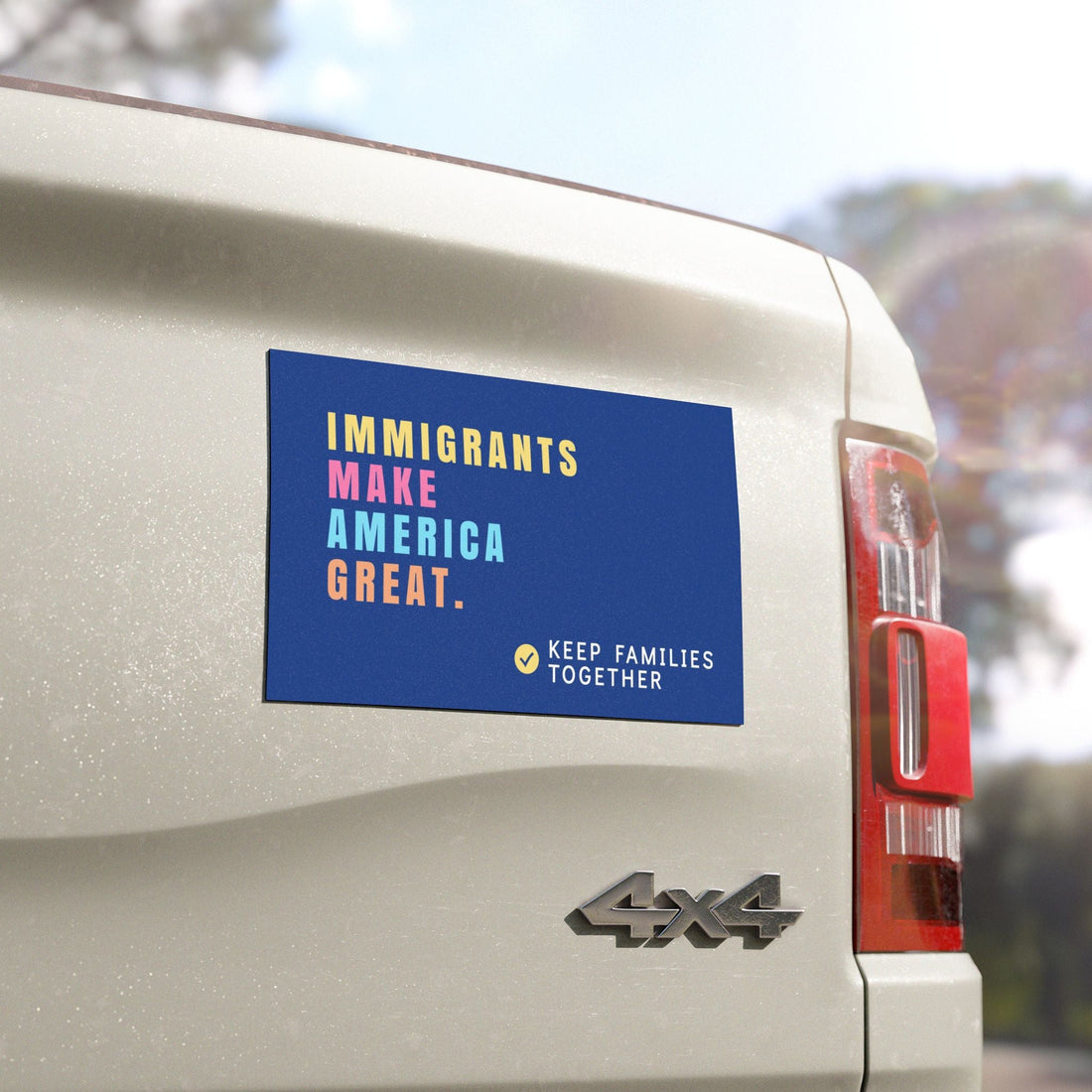 Vehicle with a political magnet on the back, featuring text "Immigrants Make America Great, Keep families together".  Anti-MAGA car magnet.