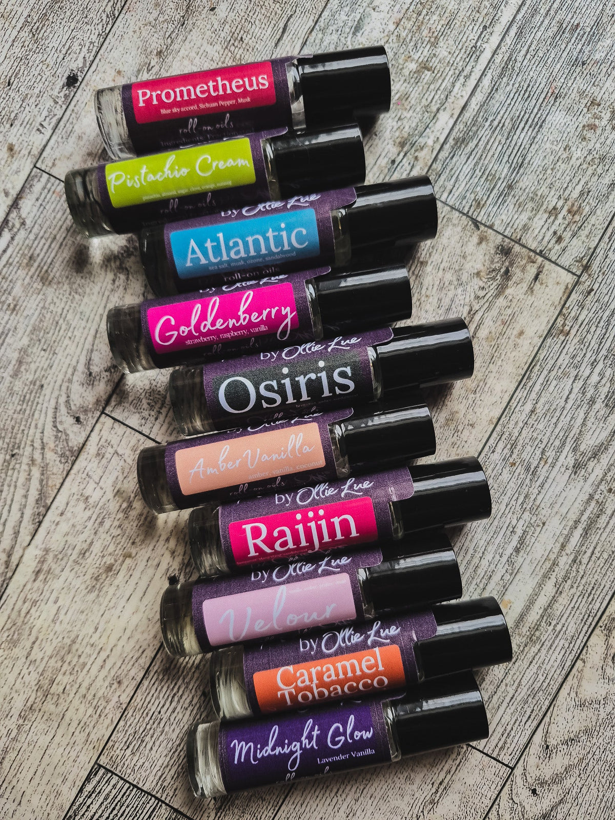 Collection of scented oil tubes with colorful labels on a dark background
