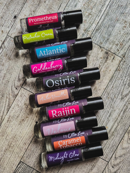 Collection of scented oil tubes with colorful labels on a dark background