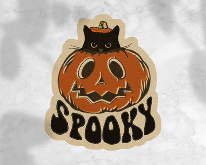 Halloween-themed sticker with a black cat on a pumpkin and &