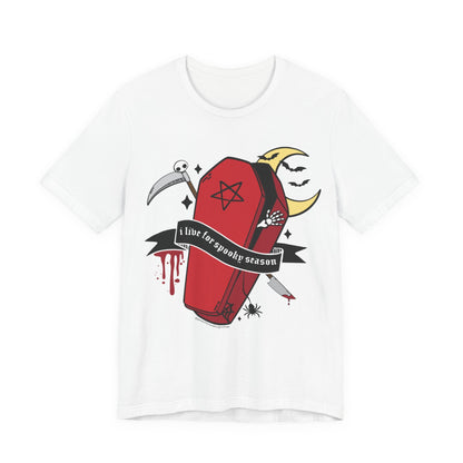 A white short-sleeve crewneck t-shirt featuring a gothic graphic print of a red coffin with a black pentagram, a black banner reading &