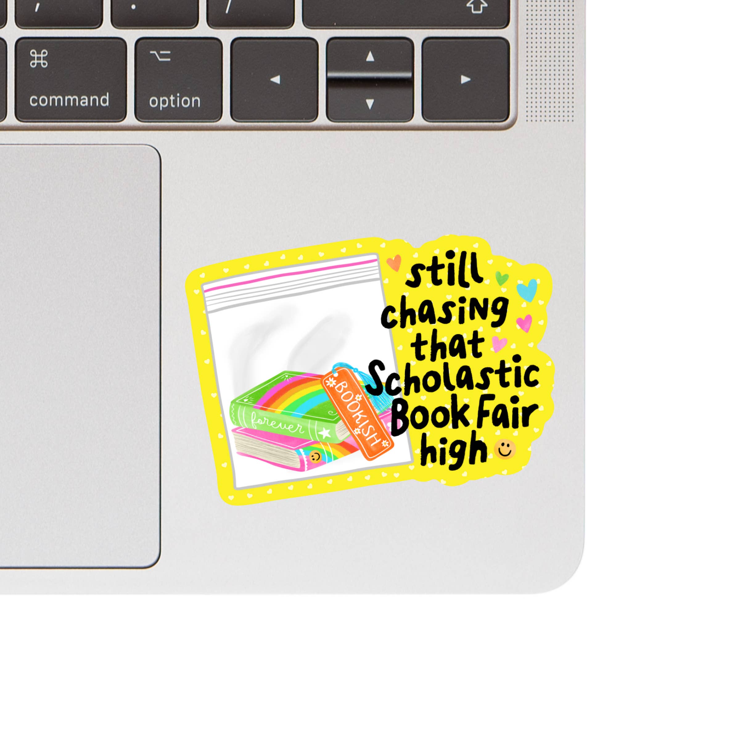 Laptop with a colorful sticker reading &