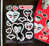 A sheet of vampire-themed water-resistant vinyl stickers on a dark wood background, next to a red sticker album cover. The stickers feature cartoon vampire faces, bats, and heart-shaped sweets with text like &