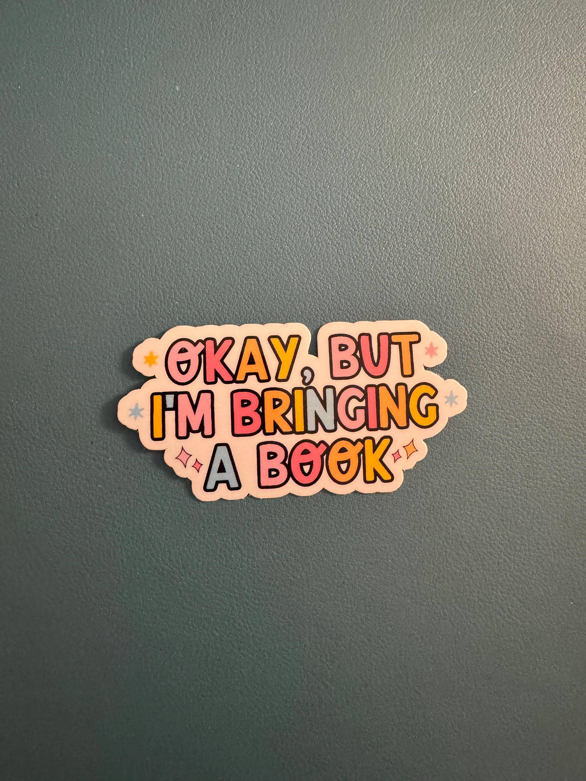 A die-cut sticker with the text &