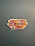 A die-cut sticker with the text &