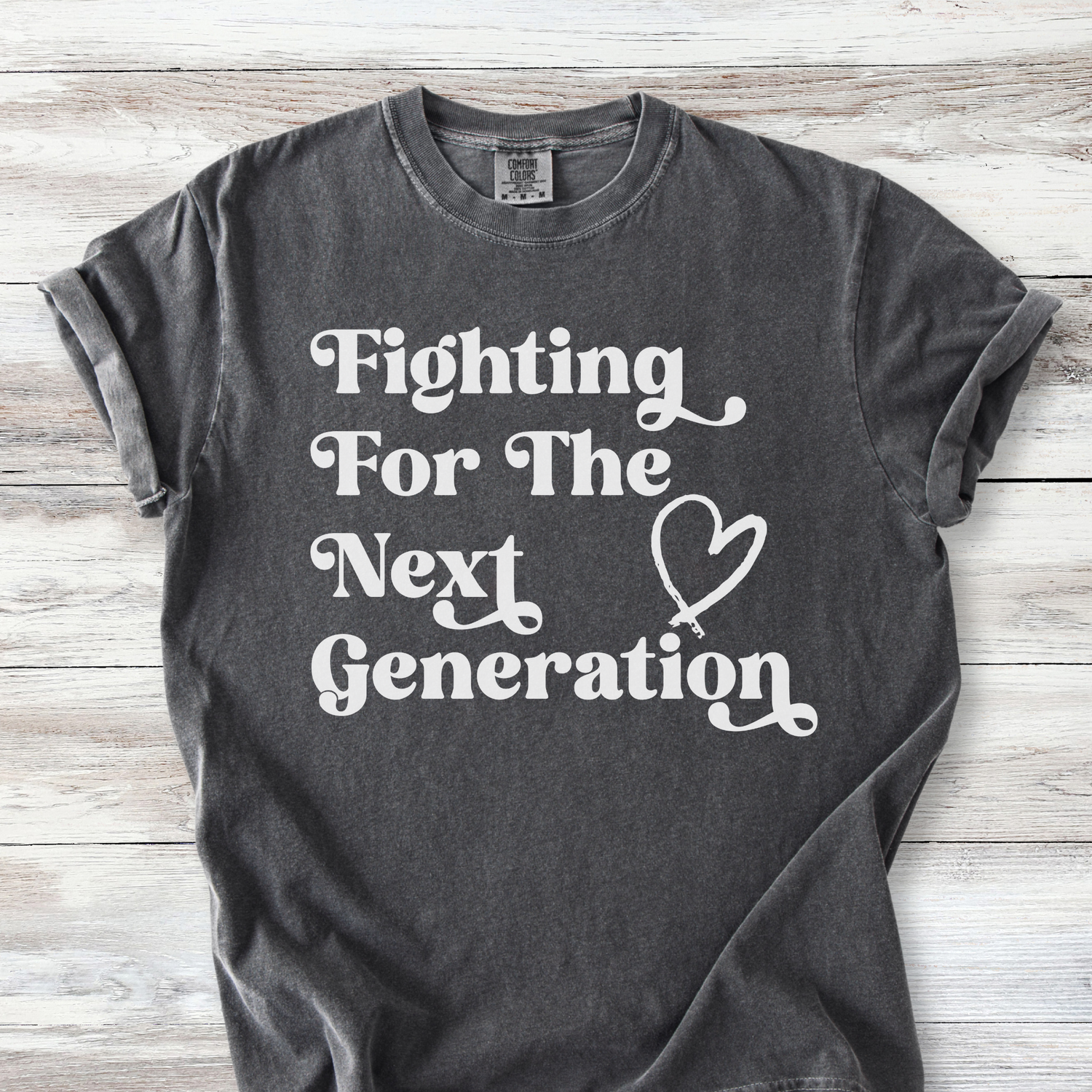 Comfort Colors unisex t-shirt with retro-style text reading "Fighting For The Next Generation" and a hand-drawn heart graphic.  Available in many colors, this listing includes Pepper, Bay, Espresso and Blossom *light pink)