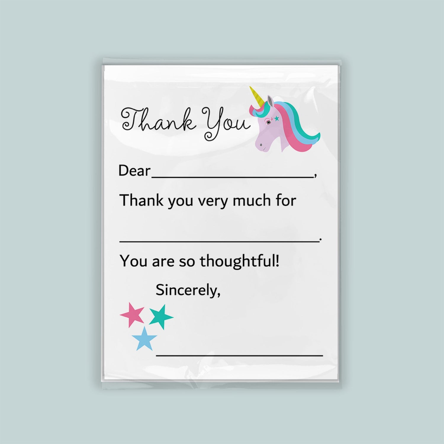 The image is a white thank you card with a unicorn illustration and stars. The card has a blank space for a recipient&