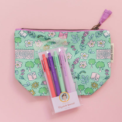 Floral-patterned pouch with pens and packaging on a pink background