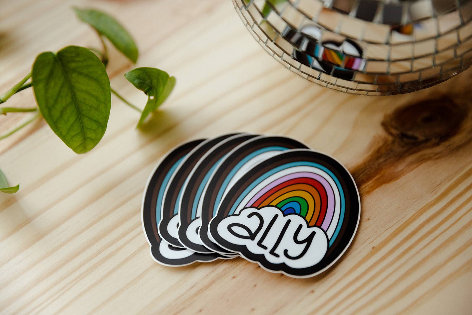 Stack of stickers with rainbow design and &